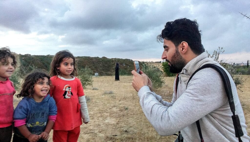 Wissam Nassar taking pictures of Palestinian children in southern Gaza